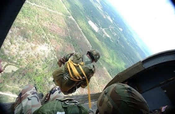 Paratroopers exiting an aircraft during airborne operations